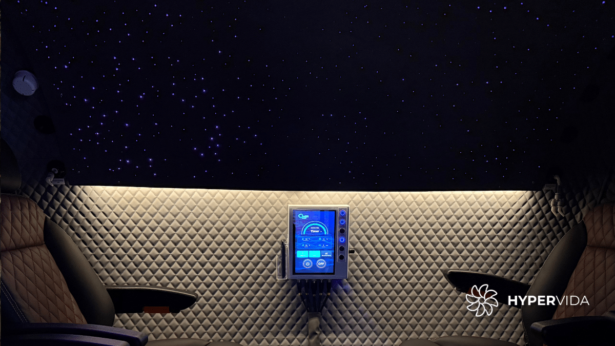 Hyperbaric oxygen therapy chamber interior with starry ceiling and control panel, relevant to the study on its effects on Fragile X Syndrome.